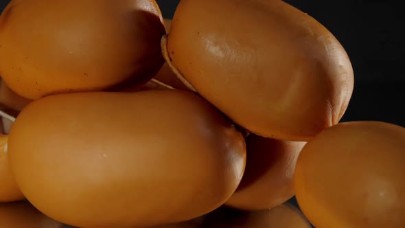 Brown Sausages with Thread Lie on Table Reflected on Glass alt