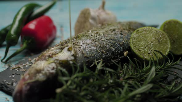 Pouring Olive Oil on Fresh Fish alt
