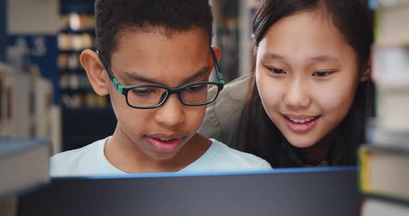 Close Up of Diverse School Students Studying and Reading Together in Library alt