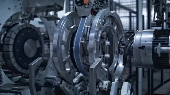 Robotic Tyre Manufacturing Equipment Rotating with Rubber Tape at Auto Plant alt