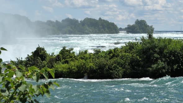 Niagara Falls In Canada-United States Border - Green Plants Growing In Niagara River With Horseshoe alt