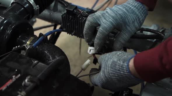 Mechanic in Car Workshop Dismantles Disconnects Electrical Circuit Under Engine