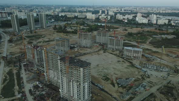 Construction site of a modern city block. High-rise buildings under construction. alt