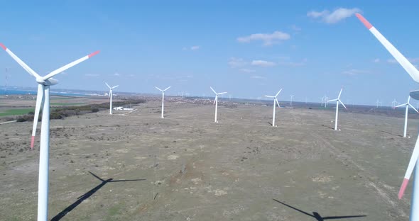 4K aerial view of windmills farm. Modern wind turbines. alt
