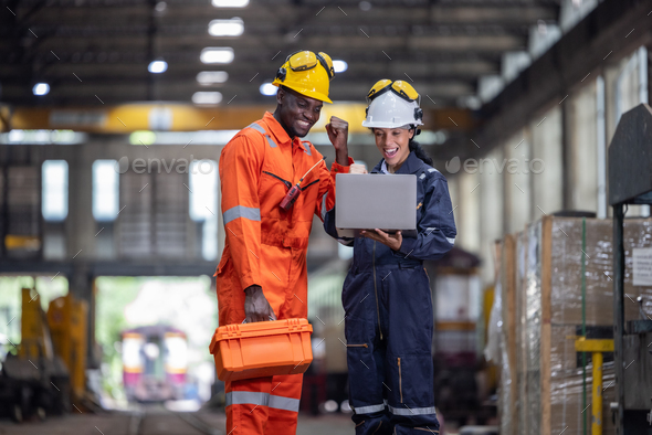Engineer supervisor uses laptop for train diagnostics, maintenance, and CO2 reduction discussions. - Stock Photo - Images