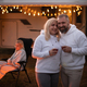 A married couple with glasses of wine stands against the background of a motorhome and rests - PhotoDune Item for Sale