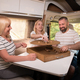 A family of three is playing a board game while sitting in a motorhome - PhotoDune Item for Sale