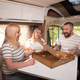 A family of three is playing a board game while sitting in a motorhome - PhotoDune Item for Sale