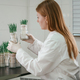 Holding plants. Woman is working in the laboratory with grass, agriculture plants - PhotoDune Item for Sale