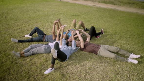 Smiling Young People Using Smartphones. alt