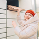 Woman with box at outdoor automated parcel machine. Modern parcel locker with many postal boxes - PhotoDune Item for Sale
