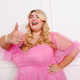 Cheerful plus size woman in elegant dress showing like gesture - PhotoDune Item for Sale