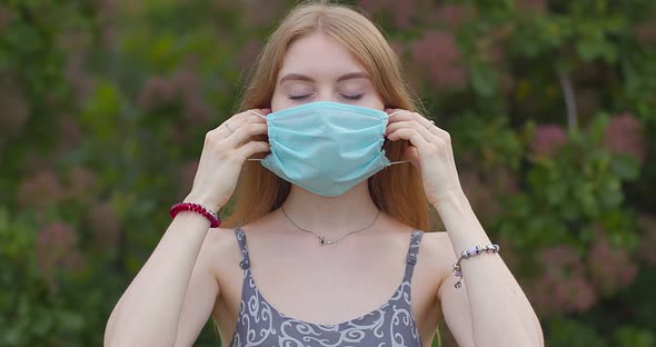 Beautiful young girl, blonde puts on a medical mask