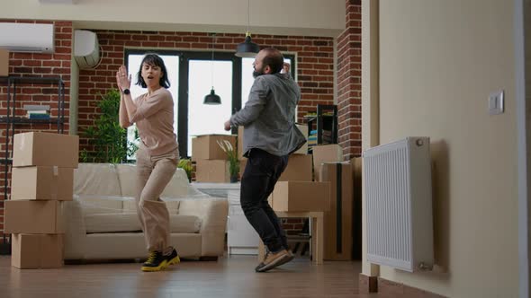 Married Couple Dancing and Celebrating Moving in Together alt