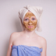 young woman with healing earth or clay beauty facial mask wrapped in towel - PhotoDune Item for Sale