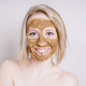 young woman with healing earth or clay beauty facial mask - PhotoDune Item for Sale