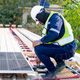 workers installing solar panels, for efficient energy on rooftop - PhotoDune Item for Sale
