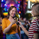 Asian woman friends hold bottle of beer, having party in front of bar.  - PhotoDune Item for Sale