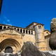 A statue of a teddy bear stands in front of a historic building in the medieval town of Santillana d - PhotoDune Item for Sale