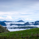 A hillside in the Asturias mountains in Spain is covered in lush green vegetation, shrouded in fog - PhotoDune Item for Sale