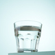 Glass of water on blue background. - PhotoDune Item for Sale