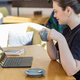 Focused Woman with Coffee Engrossed in Laptop Work - PhotoDune Item for Sale