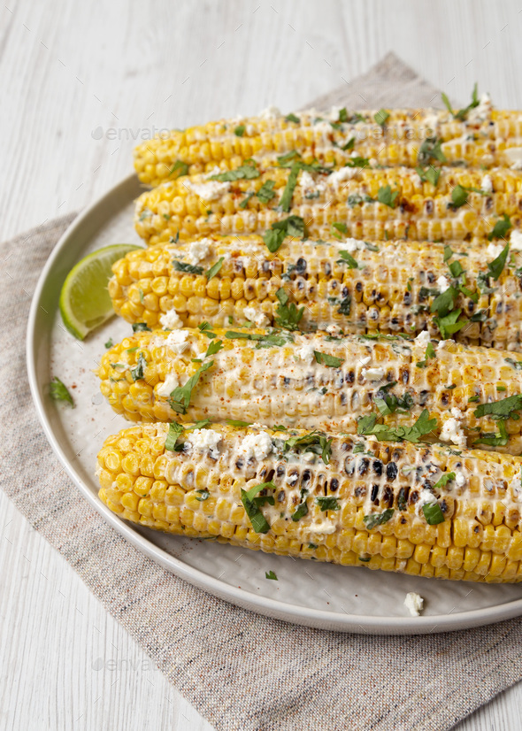 Homemade Elote Mexican Street Corn on a plate, side view. Copy space ...