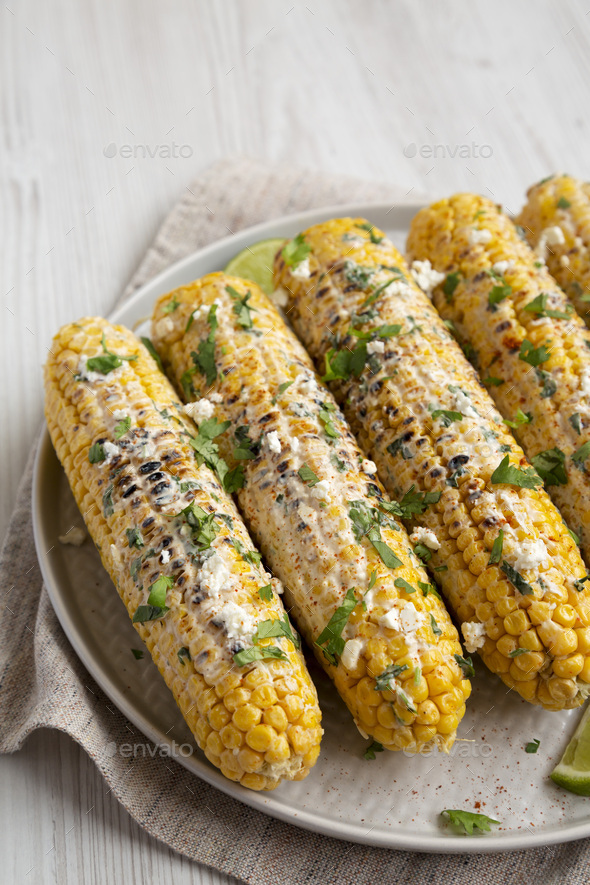 Homemade Elote Mexican Street Corn on a plate, side view. Stock Photo ...