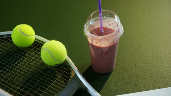Milkshake and sports equipment in tennis court 4k alt