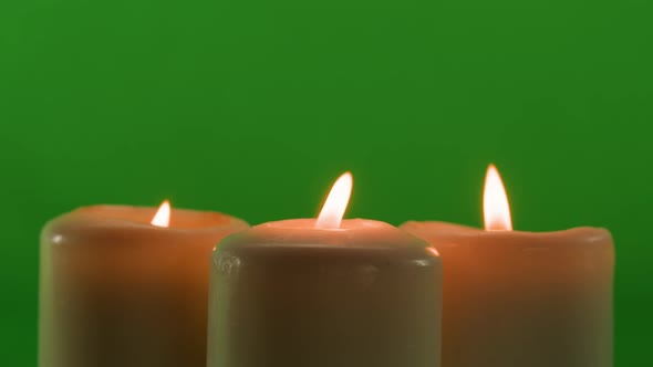 Burning Wax Candles on Green Chroma Key Background alt