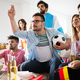 Soccer fans emotionally watching game in the living room. - PhotoDune Item for Sale