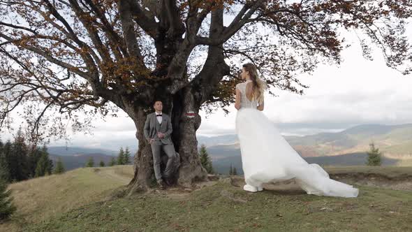 Lovely Caucasian Wedding Couple Newlyweds Family Bride Groom Stay Together on Mountain Slope Hill alt