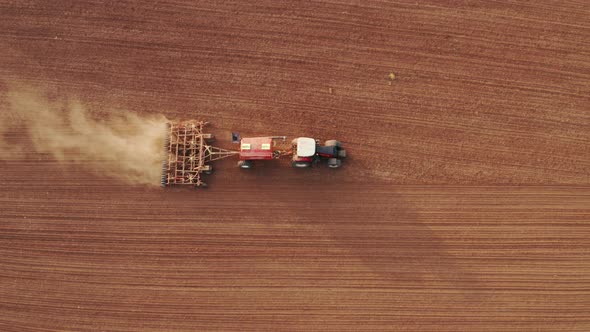 Aerial View of an Agricultural Tractor Passing the Harrow alt