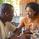 Smiling Couple Enjoying Meal With Wine At Home Together - PhotoDune Item for Sale