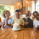 Multi-Generation Family Celebrating Grandson&#39;s Birthday At Home Blowing Out Candles On Cake - PhotoDune Item for Sale