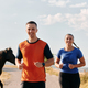 A couple dressed in sportswear runs along a scenic road during an early morning workout, enjoying - PhotoDune Item for Sale