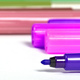 Vivid purple marker tip with assorted markers in background - PhotoDune Item for Sale