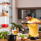 Indian asian man in kitchen cooking alone and having fun - PhotoDune Item for Sale