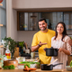 Indian couple in kitchen - Young Beautiful asian couple preparing food in home kitchen - PhotoDune Item for Sale