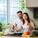 Indian couple in kitchen - Young Beautiful asian wife enjoying cooking with husband - PhotoDune Item for Sale