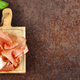prosciutto ham on a wooden board with basil - PhotoDune Item for Sale