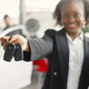 Black saleswoman standing at auto showroom and looking at camera - PhotoDune Item for Sale