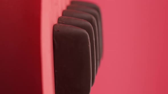 Vertical video, Close up: Composition of chocolate and candies on a red background alt