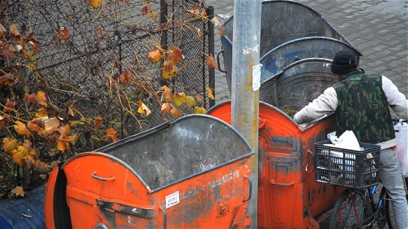 Poor Man Looking For Food In Garbage