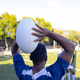 Group of three African American young male athletes training with a rugby ball on a field outdoors - PhotoDune Item for Sale