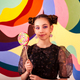 Portrait of cover child girl with round lollipop at colorful wall, looking at camera - PhotoDune Item for Sale