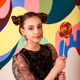 Charming cover child girl with round lollipop at colorful wall, looking at camera - PhotoDune Item for Sale
