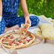 Young Girl With Broken Arm Enjoying Pizza in Sunlit Garden - PhotoDune Item for Sale