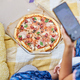 Person With a Cast on Their Arm Taking a Smartphone Photo of Pizza - PhotoDune Item for Sale