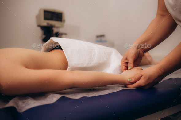 Wellness massage for children. Hands of the masseur close-up.  Physiotherapist working with Stock Photo by fentonroma